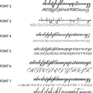 May include: Eight different font styles are shown on a white background. Each font displays the lowercase and uppercase alphabet. The fonts vary in style, from simple sans-serif to elegant cursive, offering a range of design options.