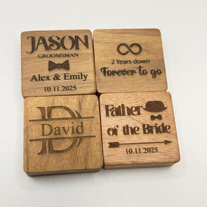 Four square wooden coasters with engraved text. One says "JASON GROOMSMAN" with "Alex & Emily" and a date. Another says "2 Years down Forever to go". A third says "David". The last says "Father of the Bride" with a date.