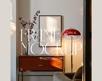 May include: A black picture frame mockup with a white background, sitting on a wooden dresser with a red lamp next to it. The text "FRAME MOCKUP PHOTOSHOP" is written in white on the image. The text "PIN A RATIO" is written in white on a red circle.