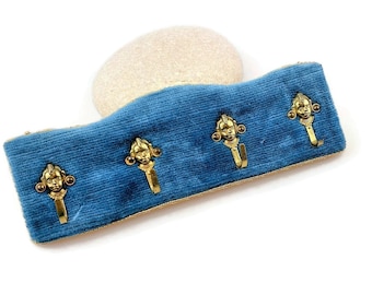 Vintage brass wall mounted coat hanger in blue velvet with cherubs boys