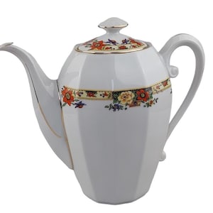 May include: White porcelain teapot with a floral design in red, orange, yellow, and blue. The teapot has a gold trim and a matching lid. The handle is curved, and the spout is slender.