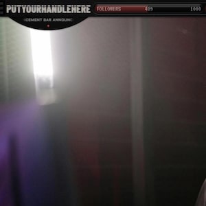 May include: A person wearing a black headset with a microphone, seated in a black and orange gaming chair. The person is smiling and looking at a computer screen. The text "PUTYOURHANDLEHERE" is visible at the top of the screen.