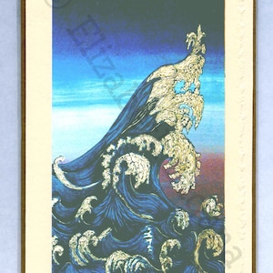 May include: A blue and gold print of a large wave crashing with the text "Ocean Wave" and the artist's signature "Laganc" at the bottom.