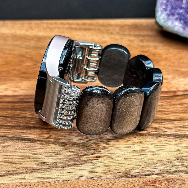 Side view of a Silver Obsidian Gemstone watch band on a wrist, highlighting the elegant design and craftsmanship.