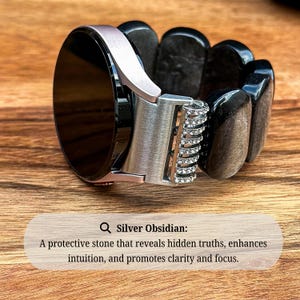Silver Obsidian Gemstone watch band on a Samsung Galaxy Watch, displayed on a textured surface to accentuate the contrast between the smooth beads and the watch face.