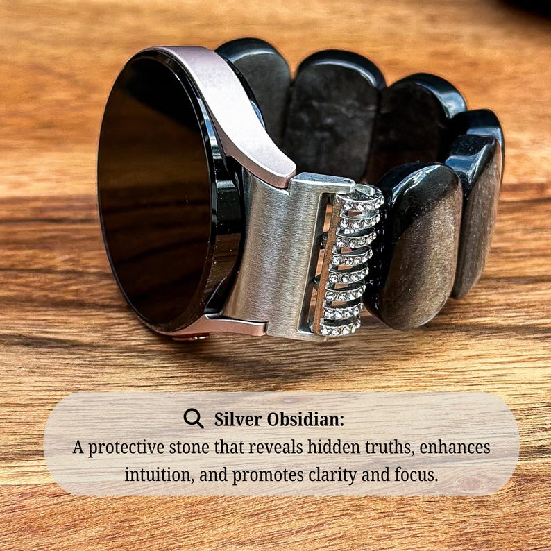 Silver Obsidian Gemstone watch band on a Samsung Galaxy Watch, displayed on a textured surface to accentuate the contrast between the smooth beads and the watch face.