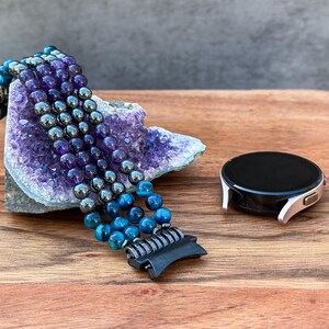 A luxurious handmade Samsung Galaxy Watch Band featuring Black Hematite, Purple Amethyst, and Blue Tiger Eye gemstones. Crafted with attention to detail, this unique band adds elegance and sophistication to your smartwatch.