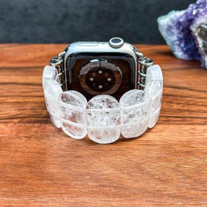 Back view of Apple Watch with handcrafted band made of oval white crystals, showing secure connectors and polished stone texture.