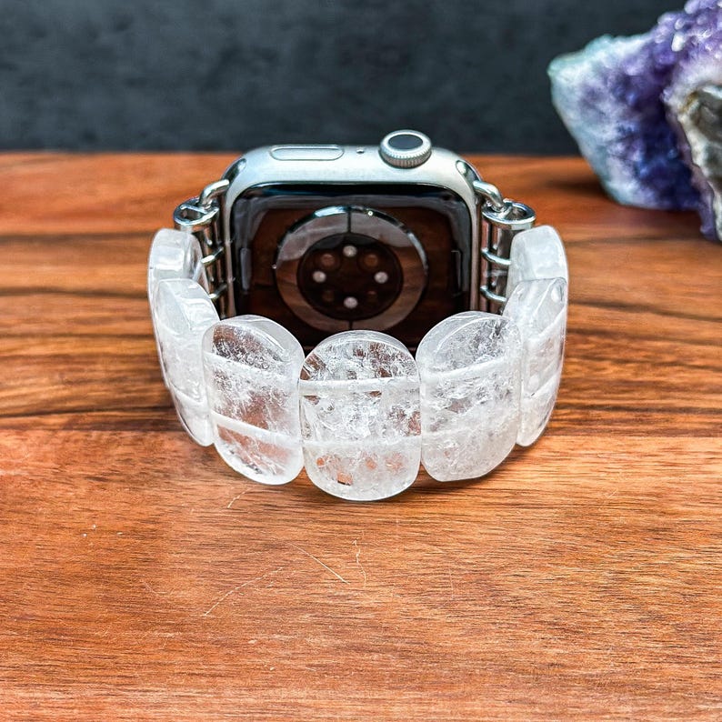 Back view of Apple Watch with handcrafted band made of oval white crystals, showing secure connectors and polished stone texture.