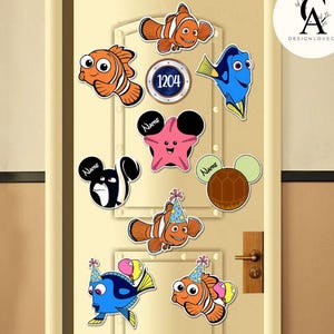May include: A set of Finding Nemo and Finding Dory themed door decorations. The decorations include characters like Dory, Nemo, Marlin, Crush, and a starfish. The decorations are perfect for a Finding Nemo themed party or for a child's bedroom.