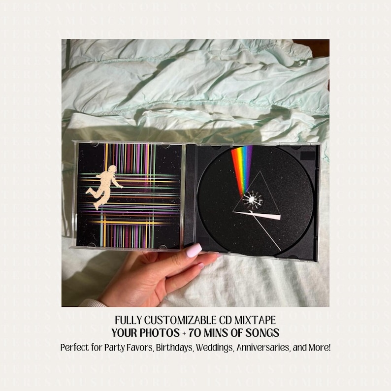 May include: A black CD case with a custom design featuring a person in a space suit and a rainbow prism. The text on the case reads "FULLY CUSTOMIZABLE CD MIXTAPE YOUR PHOTOS + 70 MINS OF SONGS Perfect for Party Favors, Birthdays, Weddings, Anniversaries, and More!"