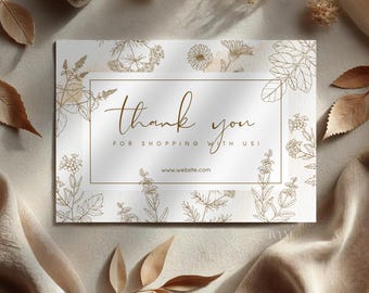 May include: A white thank you card with a floral design in brown. The card says "Thank you for shopping with us!" and includes a website address.