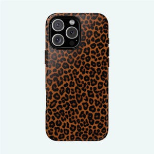 May include: A brown and black leopard print phone case for an iPhone 13 Pro Max.