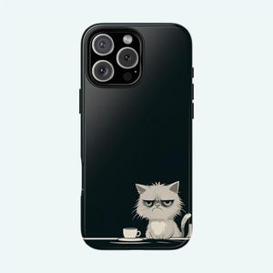 May include: Black phone case featuring a cartoon of a grumpy cat and a small cup on a table. The phone case has a black background and a camera lens with four circles.