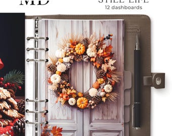 May include: A brown leather planner with a silver ring binder. The planner has a page with a fall-themed wreath with pumpkins, pinecones, and leaves. The text "Printable planner dashboards STILL LIFE 12 dashboards" is printed on the cover.