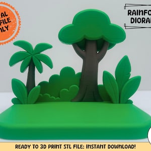May include: A 3D printed rainforest diorama featuring a central brown tree, a smaller palm tree, and green bushes on a flat green base. Text on the image reads: DIGITAL STL FILE ONLY, RAINFOREST DIORAMA:, READY TO 3D PRINT STL FILE: INSTANT DOWNLOAD.