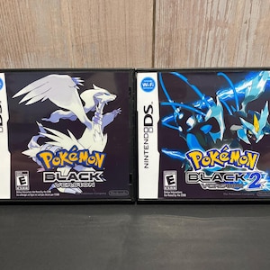 May include: Two Nintendo DS game cartridges for Pokemon Black and Pokemon Black 2. The Pokemon Black cartridge features a white Pokemon with blue eyes and a black background. The Pokemon Black 2 cartridge features a blue Pokemon with red eyes and a black background.