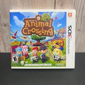 May include: A Nintendo 3DS game case for "Animal Crossing: New Leaf." The cover art features a vibrant scene with cartoon characters, a tree, and the game's title. The game is rated "E" for Everyone by the ESRB.