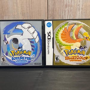 May include: Two Nintendo DS game cartridges, one for Pokemon SoulSilver Version and one for Pokemon HeartGold Version. Both cartridges are black with a silver trim and feature the Pokemon logo.