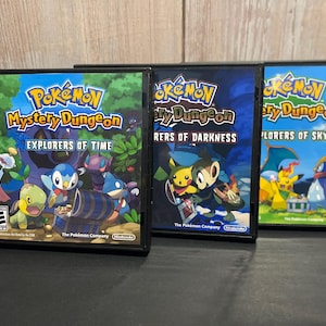 May include: Three Nintendo DS game cartridges for Pokemon Mystery Dungeon: Explorers of Time, Explorers of Darkness, and Explorers of Sky. The cartridges are black with colorful artwork featuring Pokemon characters.