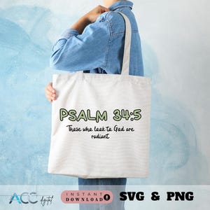 May include: A white tote bag with the text "PSALM 34:5 Those who look to God are radiant" printed on it.