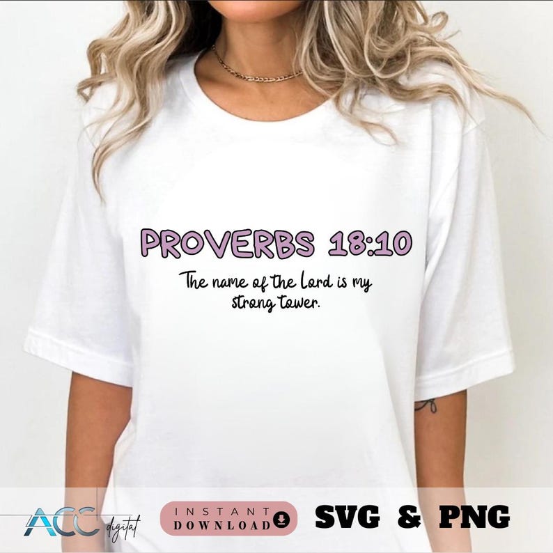 May include: White t-shirt with a pink and black graphic that says "PROVERBS 18:10 The name of the Lord is my strong tower."
