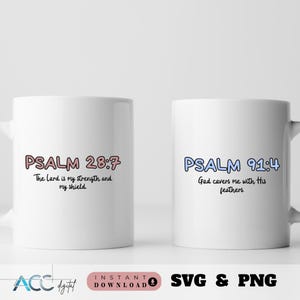 May include: Two white mugs with black text and colorful outlines. The mug on the left says "PSALM 28:7 The Lord is my strength and my shield." The mug on the right says "PSALM 91:4 God covers me with His feathers."