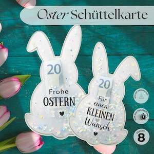 以下が含まれることがあります： 「Oster Schüttelkarte」の文字が入った、ウサギの形をした白いイースターカードが2枚。各カードには20の紙幣と「Frohe OSTERN」と「Für einen KLEINEN Wunsch」の文字が入っています。カードは紙吹雪で飾られています。