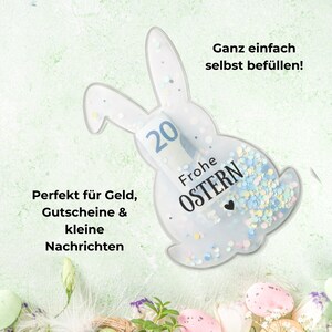 May include: A clear, bunny-shaped container filled with confetti and a twenty-dollar bill. The container has the words "Frohe OSTERN" printed on it. Text on the image reads "Perfect for money, gift certificates & small messages" and "Easy to fill yourself!"