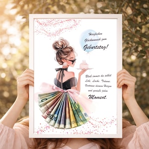 May include: A framed art print featuring a stylish illustration of a woman holding a cake. The artwork includes the German text "Herzlichen Glückwunsch zum Geburtstag!" and inspirational phrases. The woman's skirt is made of folded banknotes.