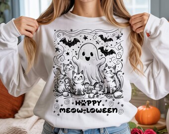 Puede incluir: Sudadera blanca con un gráfico en blanco y negro con temática de Halloween. El diseño presenta un fantasma amigable, varios gatos, murciélagos, estrellas y el texto "Happy Meow-loween". Un diseño festivo y divertido para Halloween.