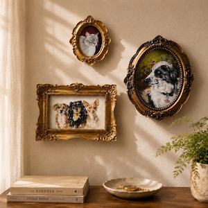 May include: Three ornate gold frames containing pet portraits are displayed on a wall. One oval frame holds a cat, another oval frame holds a black and white dog, and a rectangular frame holds three small dogs. The frames feature intricate carvings.