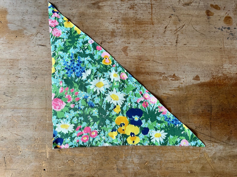 triangular fabric scrap from Bloomcraft in the 1970s with flowers and grasses