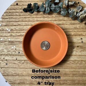 May include: A terracotta tray with a diameter of 4 inches. The tray is on a wooden surface with gold glitter stars scattered around it. The text "Before/size comparison 4" tray" is written below the tray.