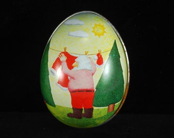 VTG Egg Shaped Tin Santa hanging his Clothes Summer Scene Made in Switzerland Keepsake Stash Tin