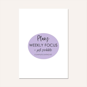May include: A white card with a light purple oval containing the words "Plans WEEKLY FOCUS by just scribble COMPLETE DATING KIT" in black script. The card is on a cream-colored background.