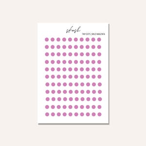 May include: A sheet of stickers with small, light purple dots. The sheet is white and has the text "skosh TINY DOTS | MILD MAGENTA" at the top.