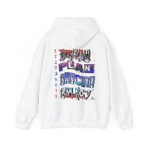 May include: White hoodie with the words "DREAM, PLAN, EXECUTE, ENJOY" in a colorful, glitch-style font on the back. The word "STOLEN SHIRTS" is printed vertically on the left side. The hoodie has a hood and long sleeves.