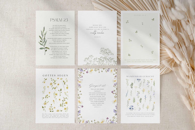 May include: Six white cards with floral designs and text. The cards feature various botanical illustrations, including sprigs, wildflowers, and delicate blooms in shades of green, yellow, and purple. The text is in a script font.