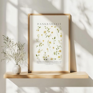 Könnte beinhalten: Ein gerahmter Druck mit dem Wort "Dankbarkeit" in einer modernen Schrift. Der Druck zeigt eine Aquarell-Illustration von gelben Blumen und grünen Blättern auf weißem Hintergrund. Der Text unter der Illustration lautet: "Seid allzeit fröhlich, betet ohne Unterlass, und danket in allem; denn das ist der Wille Gottes in Christus Jesus für euch." (1 Thessalonicher 5:16-18)