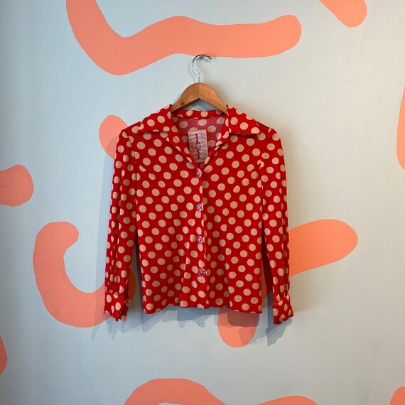 red blouse with white polka dots