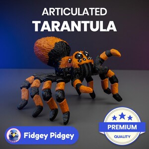 Könnte beinhalten: Articuliertes Spielzeug-Tarantel mit schwarzen und orangefarbenen Beinen und einem schwarzen Körper. Das Spielzeug ist mit ausgestreckten Beinen aufgestellt. Das Spielzeug ist mit "Articulated Tarantula" und "Premium Quality" beschriftet.