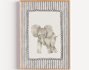 May include: A framed watercolor print of a baby elephant. The elephant is gray with large ears and a trunk. The print is set against a light gray background with a black scalloped border and a striped pattern.