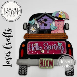 May include: A black wooden truck with a spring theme. It features a birdhouse, watering can, umbrella, and rain boots. The truck bed says "Hello Spring" and "Bloom". The design includes birds, a butterfly, and flowers.