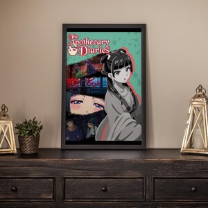 May include: Framed art print featuring anime-style artwork. The print showcases a female character with black hair and a traditional outfit, set against a teal background. The title "The Apothecary Diaries" is visible at the top. The artwork is displayed on a dark wooden surface.
