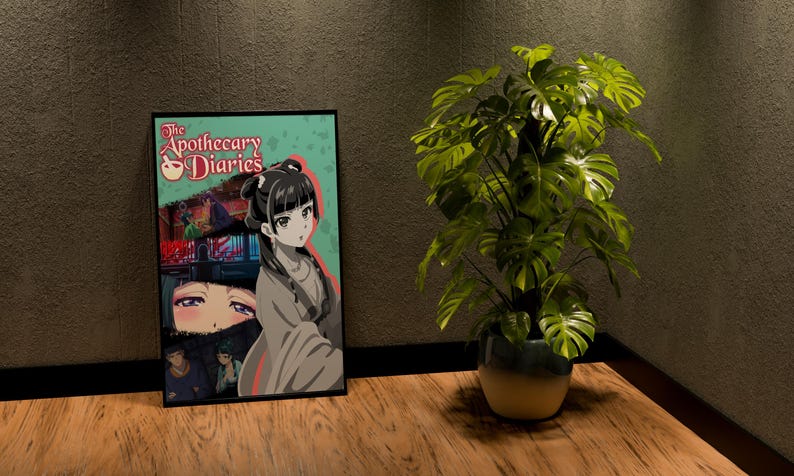 May include: A framed poster featuring anime-style artwork with the title "The Apothecary Diaries." The poster is propped against a wall next to a potted Monstera plant with large, green leaves. The poster has a teal background.