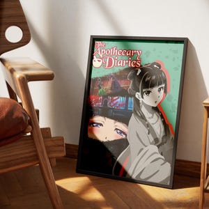 May include: Framed poster featuring anime-style artwork from "The Apothecary Diaries." The poster has a black frame and depicts a woman in traditional clothing, with the title text at the top. The background is a mix of colors.
