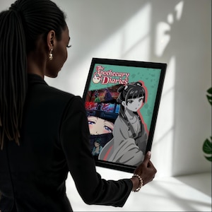 May include: A framed print of "The Apothecary Diaries" anime. The artwork features a grayscale illustration of a woman in traditional clothing, with a colorful background and the title text at the top. The frame is black.