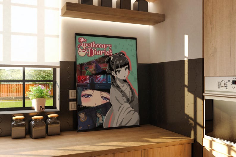May include: Framed poster featuring anime-style artwork. The poster has a teal background with the text "The Apothecary Diaries" and illustrations of characters. The artwork is displayed in a kitchen setting, with a window and wooden cabinets.