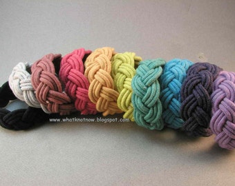 May include: A set of nine braided headbands in various colors, including white, pink, yellow, green, blue, dark blue, and purple. The headbands are made of a soft, rope-like material and are perfect for adding a touch of color to any outfit.